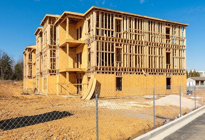 a close-up of temporary chain link fences enclosing a job site, signaling progress in the project's development in New Haven, IN